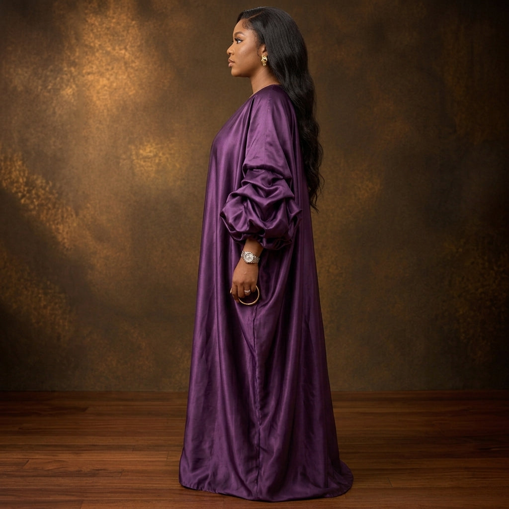 ASAKE-OGE Abeni luxury kaftan boubou in royal purple with a shawl neckline and sculptural sleeves, styled on a model