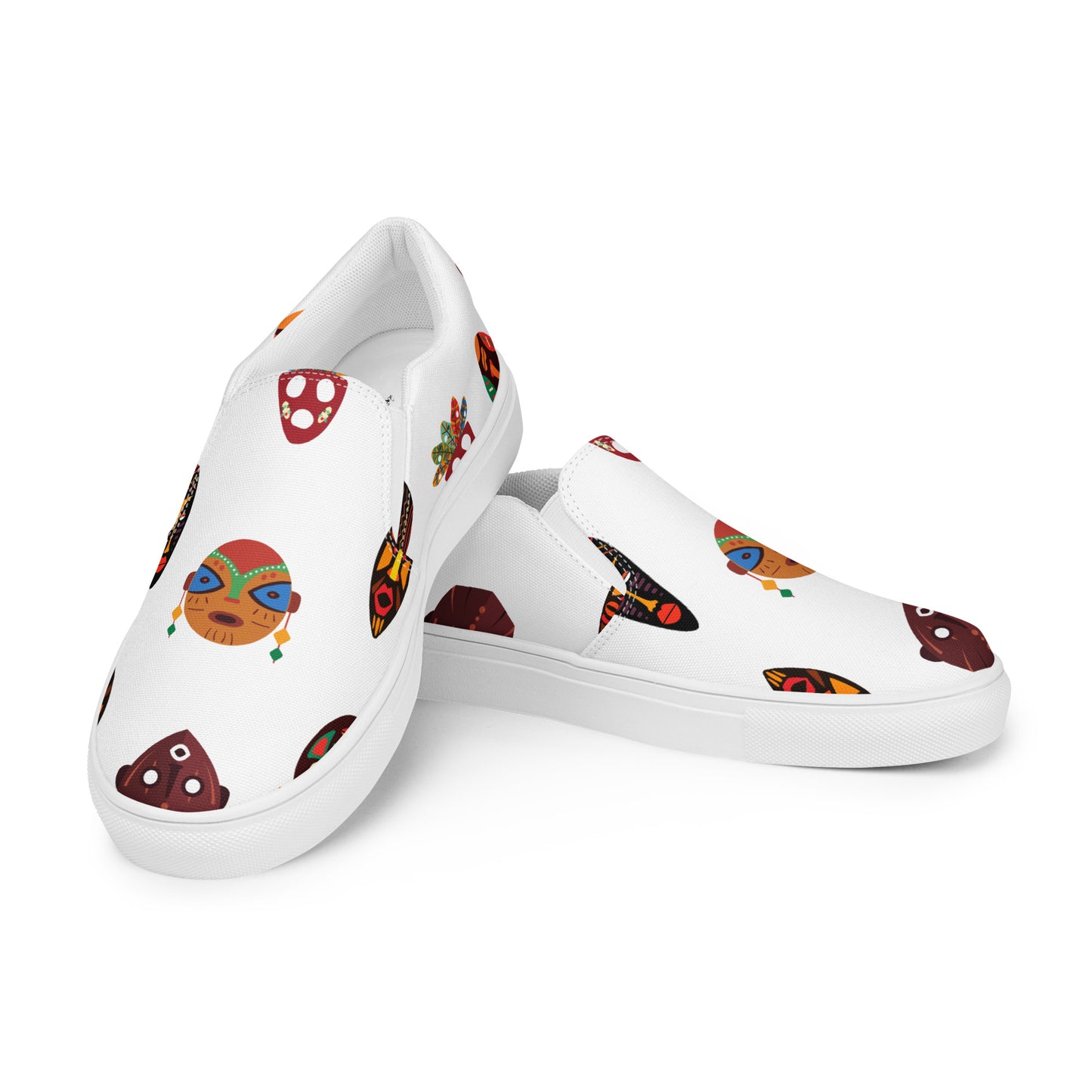 A pair of men's slip-on canvas shoes with a white base and a design featuring colorful tribal mask patterns.