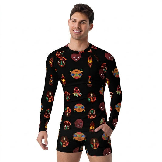 A man modeling a black long-sleeve rash guard and matching black swim trunks, both featuring a colorful repeating pattern of cartoon masks and faces, against a plain white background.