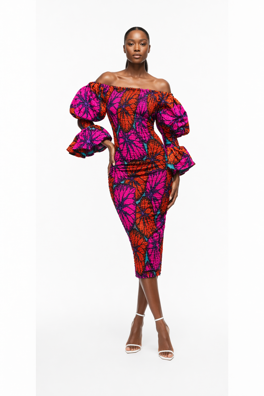 Woman wearing a colorful off-shoulder dress on a white background