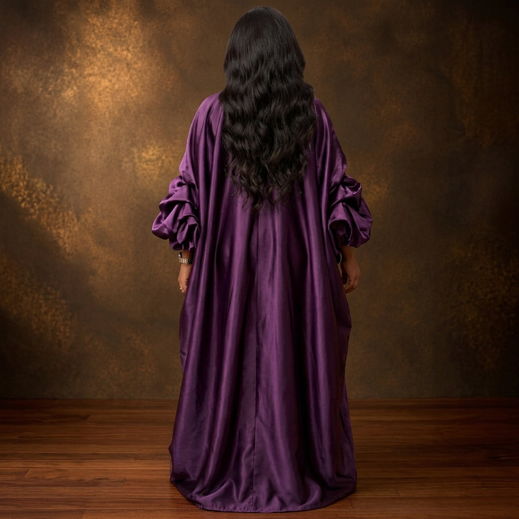 Rear view of the ASAKE-OGE Abeni kaftan boubou showing its flowing full-length silhouette and voluminous sleeves.