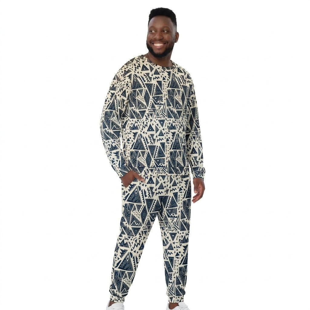 A man modeling a matching long-sleeve crewneck sweatshirt and jogger pants set with a navy blue and off-white geometric pattern, set against a plain white background.