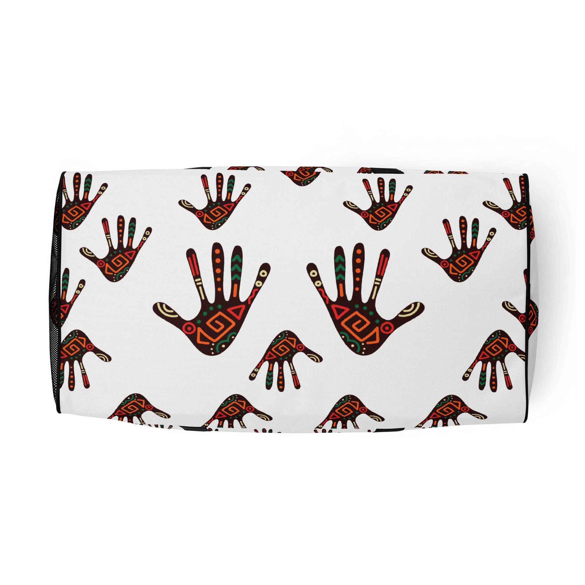 Bottom view of a white duffle bag, covered with a colorful tribal palm print design, featuring multiple pockets, a black adjustable padded shoulder strap, and dual padded handles.