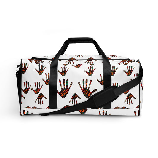 Side view of White Duro Duffle Bag; covered with a colorful tribal palm print design;  showing the dual hand carriers strapped up, while the longer single shoulder strap is dropped down and along the front of the bag. 