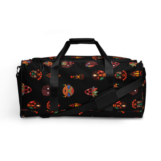 Front view of Chi Midnight Tribal Mask Duffle Bag, showing the dual hand carriers strapped up, while the longer single shoulder strap is dropped down and crosses the front of the bag. 