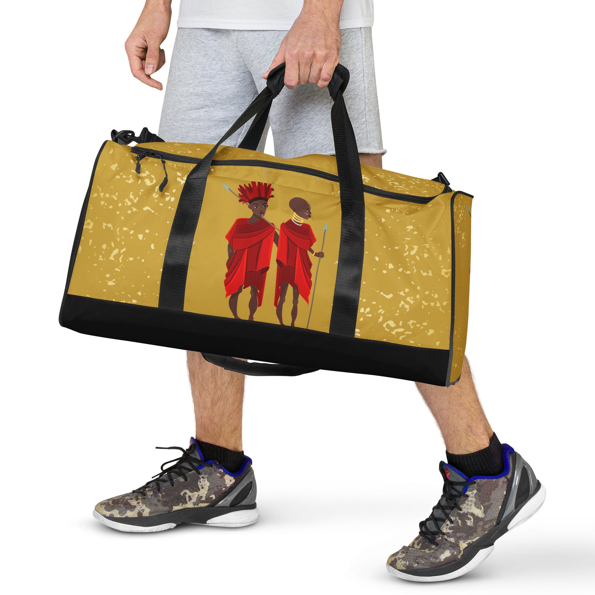 Front view of a man holding the Agojie Gold Duffle bag by hand, with its dual shorter straps;  showing the side-frontal view up close.