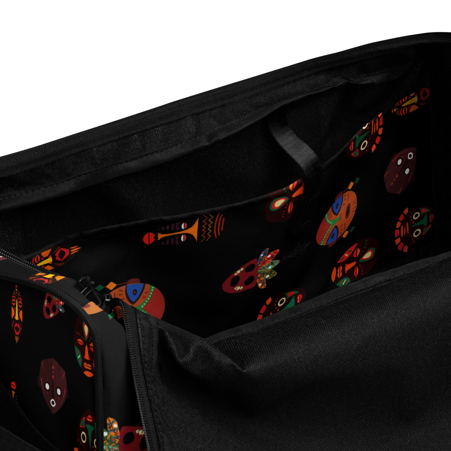 Spacious inside side pocket of Chi Midnight Duffle Bag; clothed in the custom Tribal Mask design on black background.