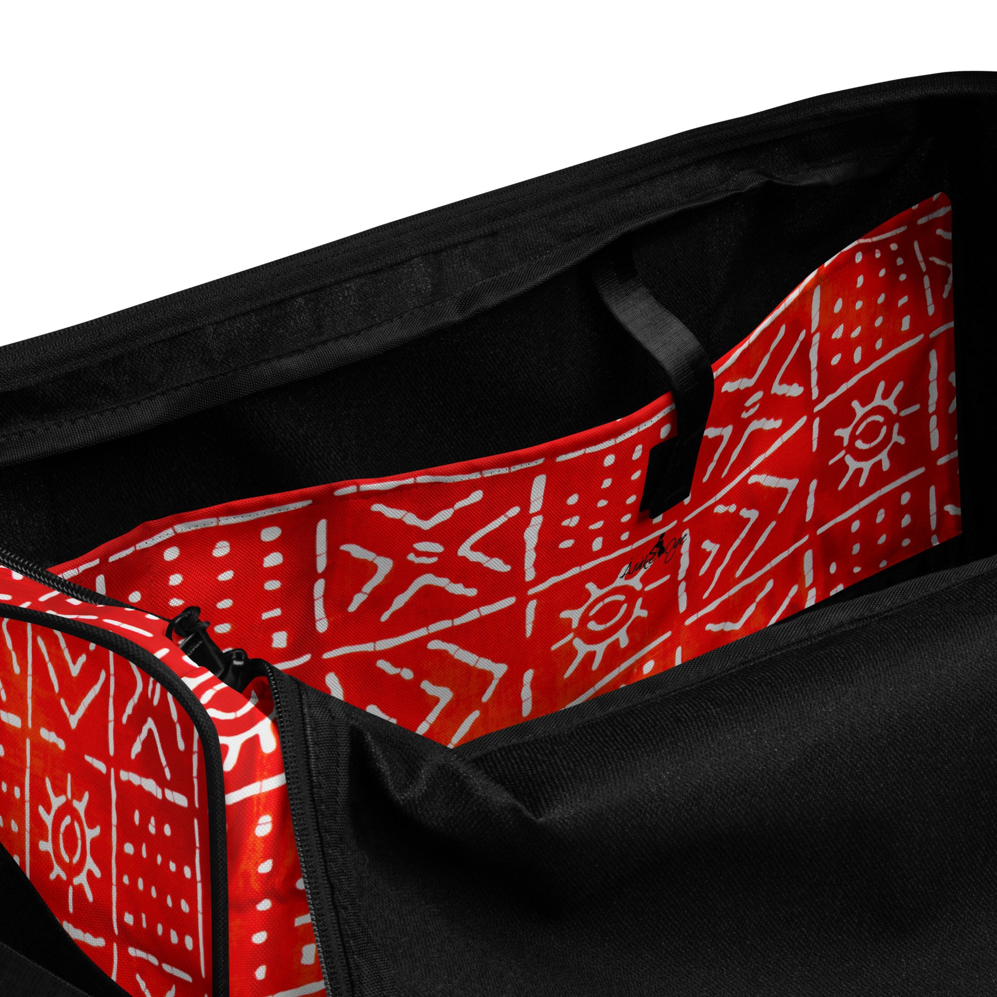Spacious inside side pocket of Aquila Print Duffle bag; clothed in the custom geometric tribal patterns on a red background.
