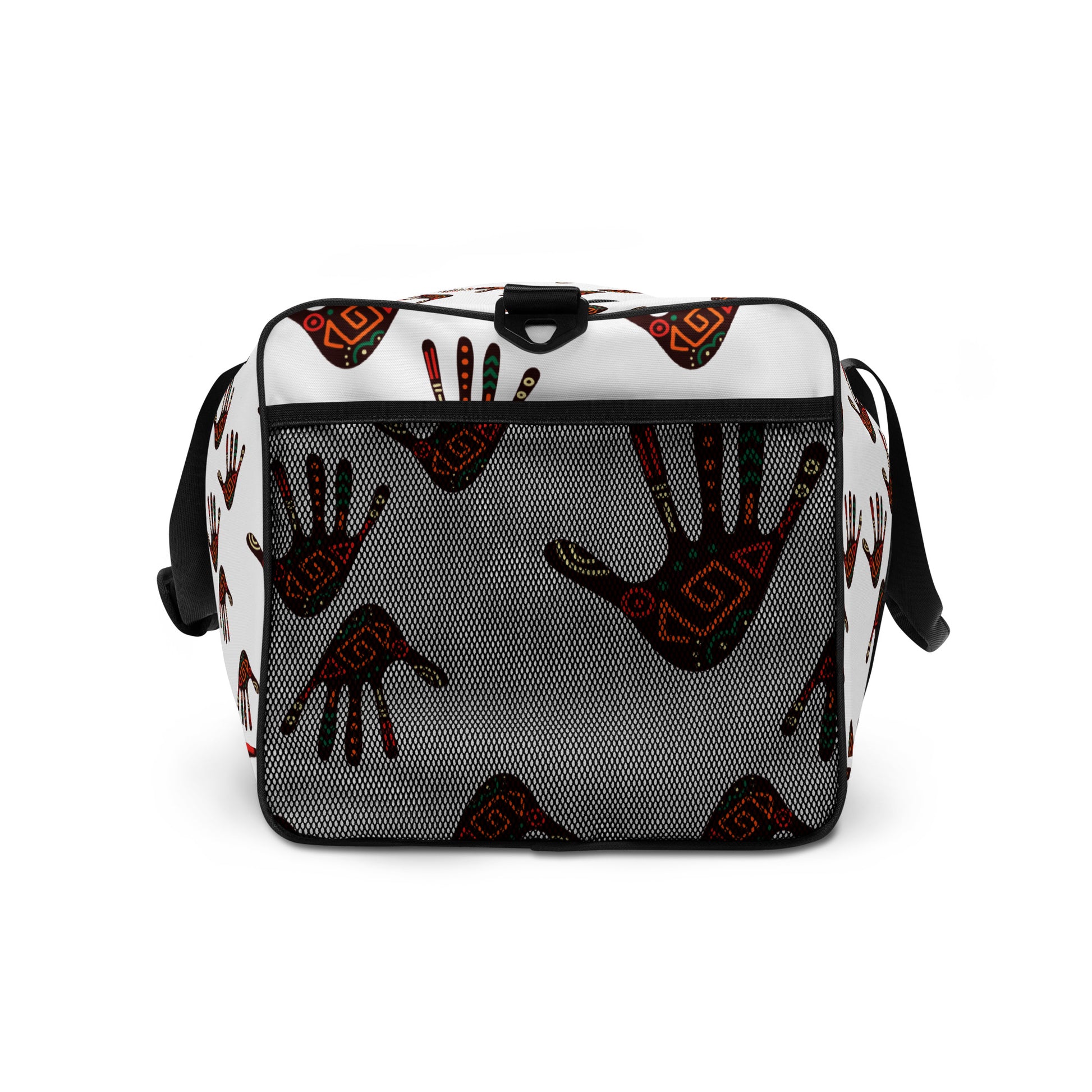 Up close view of external mesh pocket on a white duffle bag, covered with a colorful tribal palm print design, featuring multiple pockets, a black adjustable padded shoulder strap, and dual padded handles.