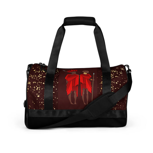 Front view of the wine-colored Agojie Burgundy Gym Overnight Bag showcasing the vibrant gold flecks and custom Sahara warriors clothed in red wrappers.