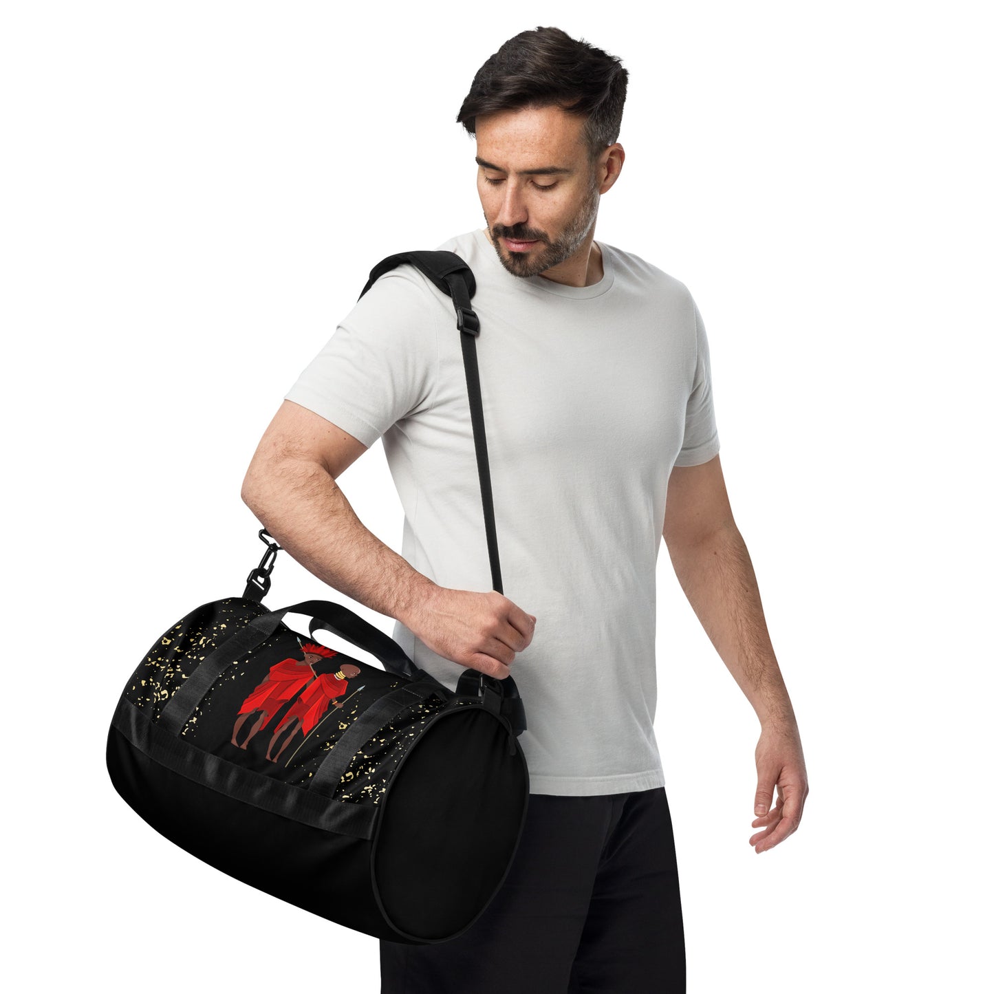 A man carrying the Agojie Midnight Overnight Gym Bag with the padded long straps on his shoulder; showcasing the circle-shaped side view.