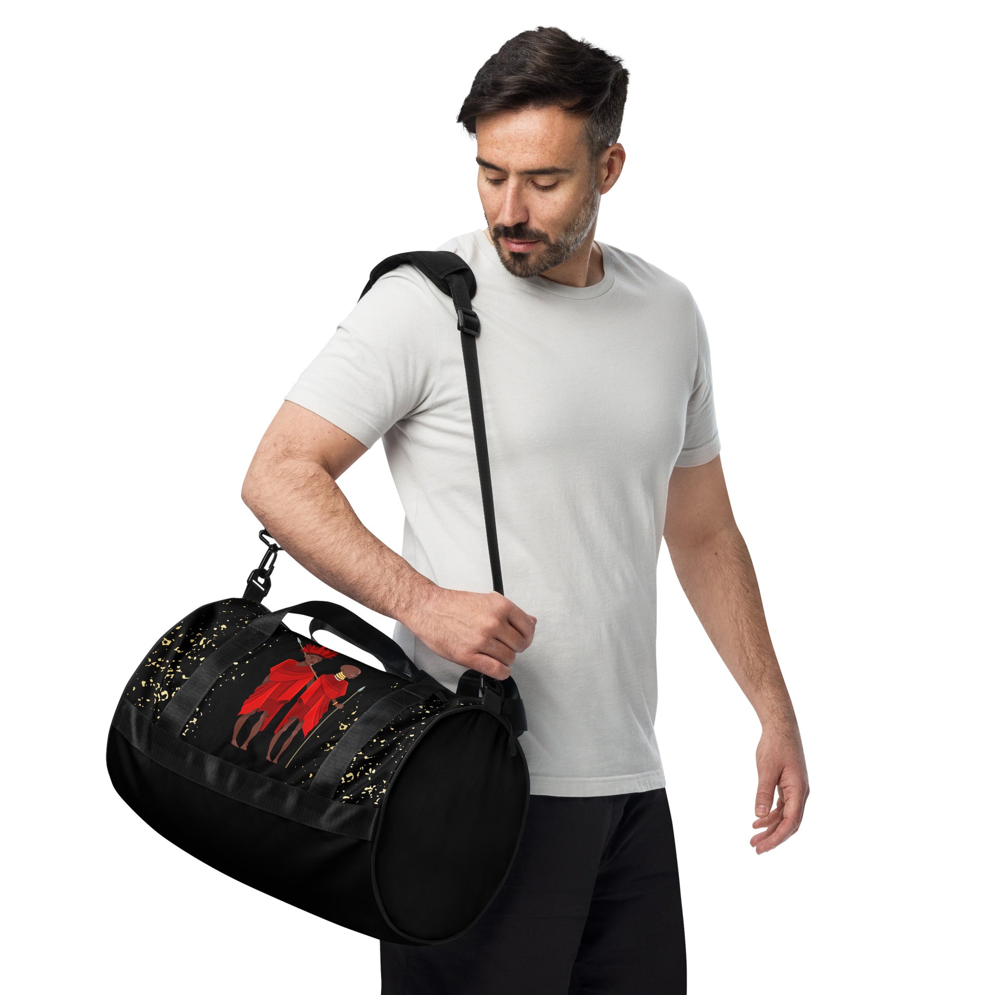 A man carrying the Agojie Midnight Overnight Gym Bag with the padded long straps on his shoulder; showcasing the circle-shaped side view.