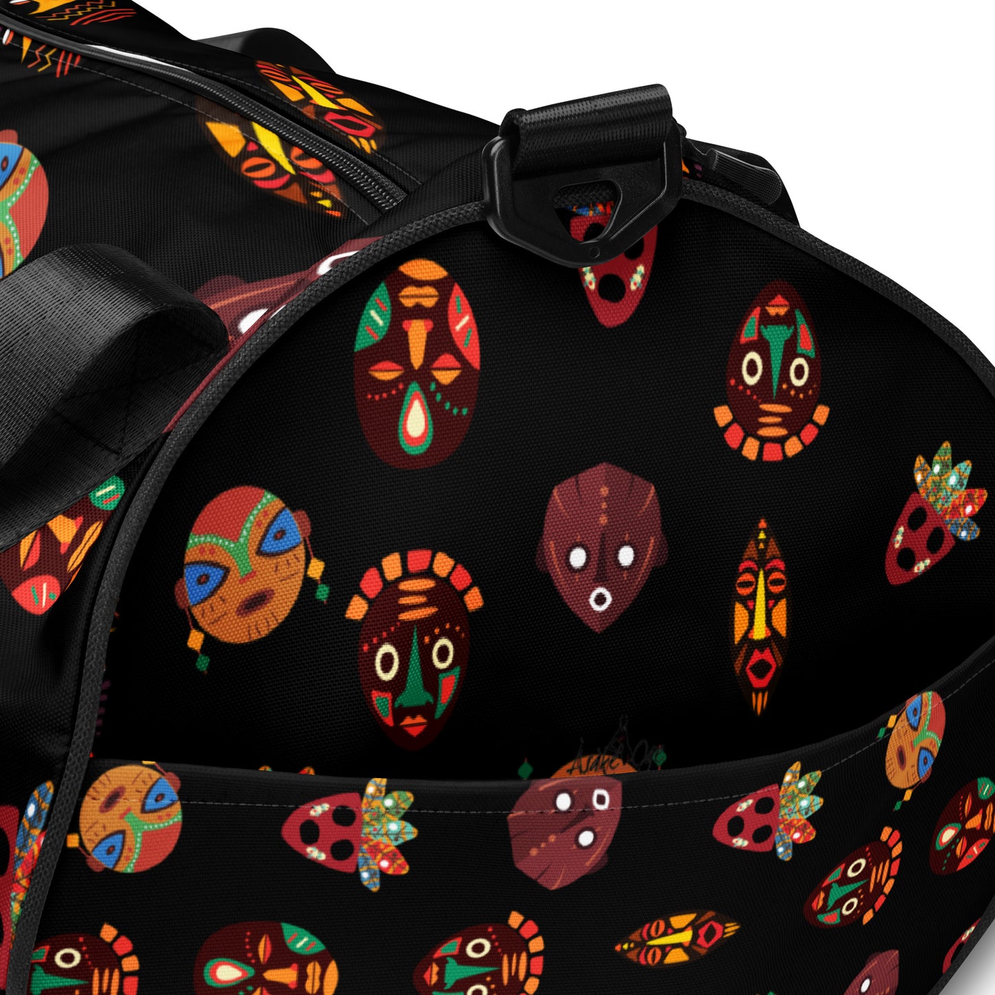 Closeup side view of Chi Midnight Tribal Mask Overnight Gym Bag, showing the Asake Oge brand logo and external pocket
