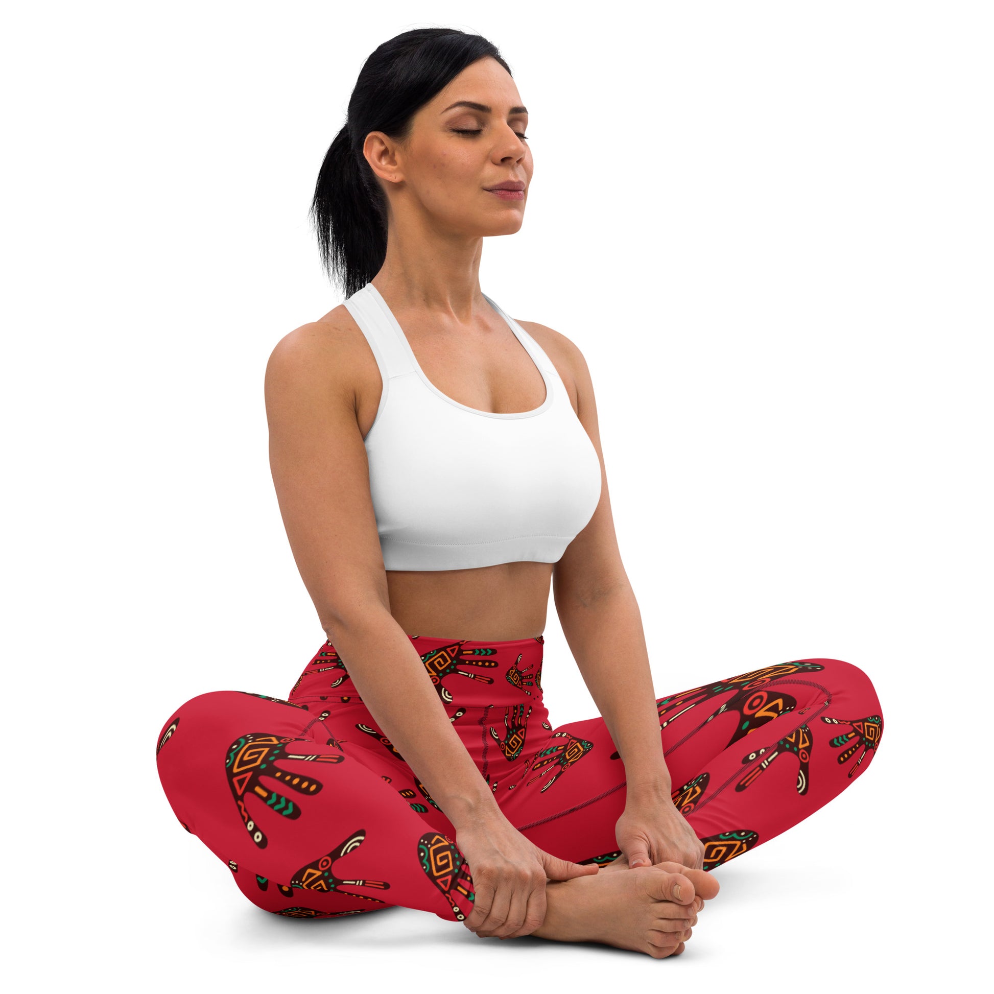 Front view of woman sitting, wearing Duro Tribal Palm Print Athleisure Leggings and doing a yoga pose