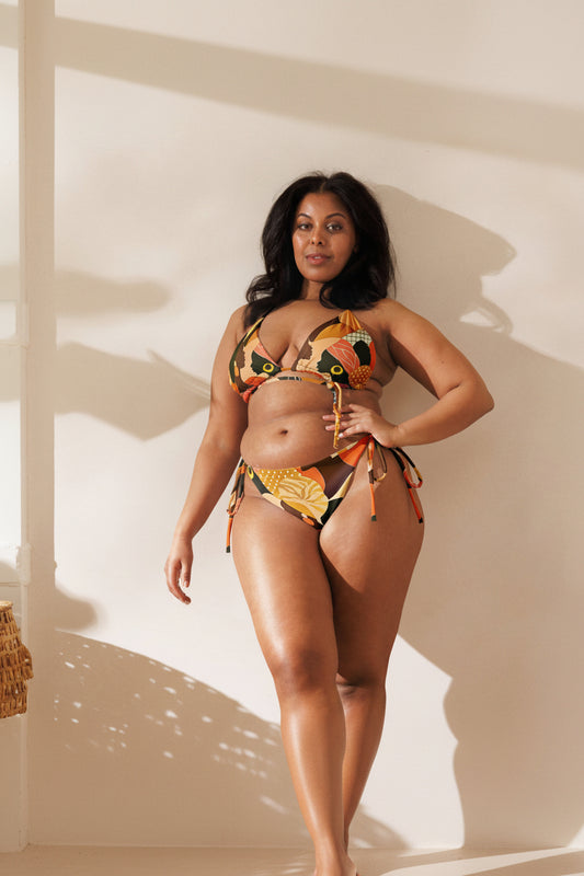 Model wearing ASAKE-OGE ÀWỌN ÀYÁ Juneteenth string bikini from the ROOTED IN FREEDOM™ collection mockup