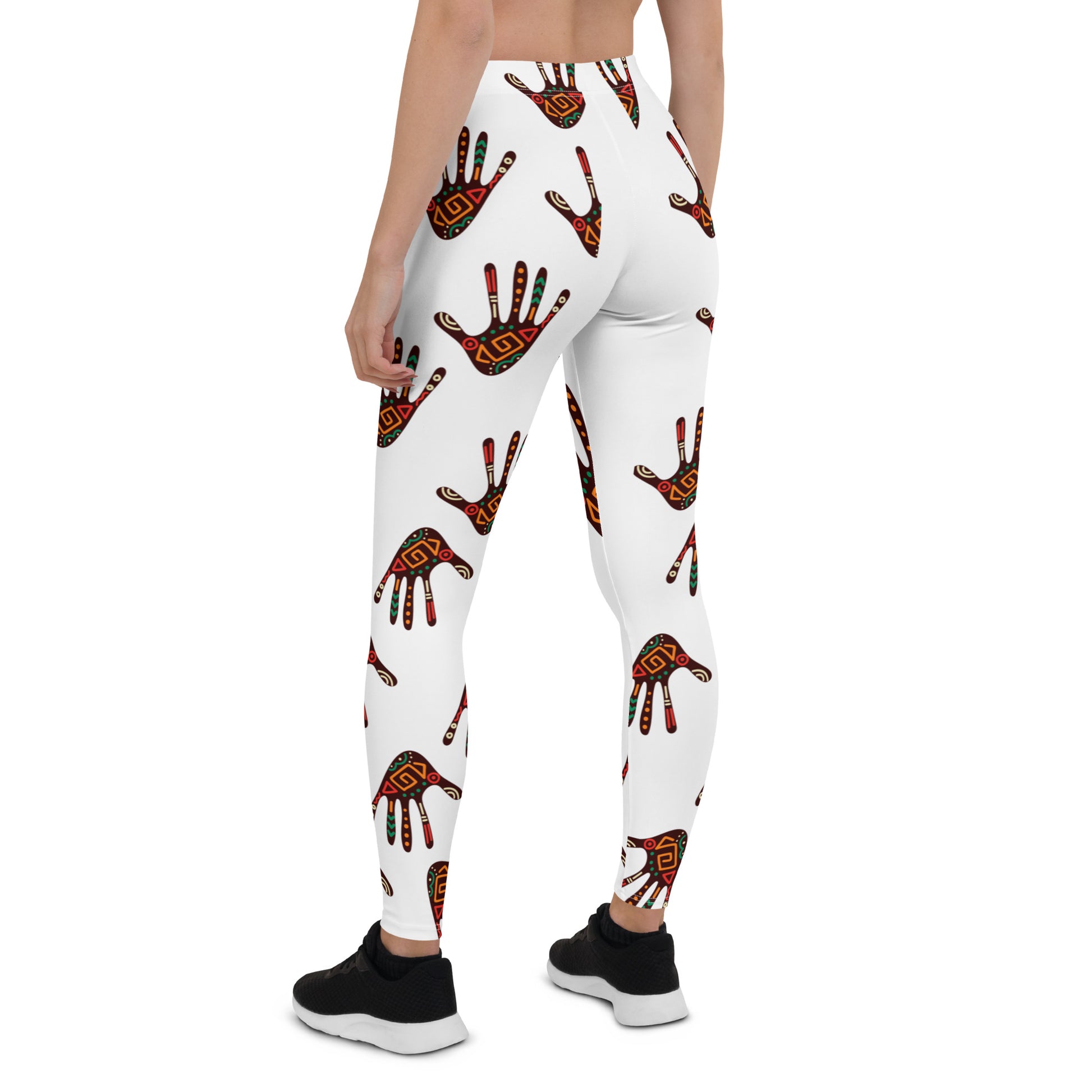 A pair of white leggings with a tribal palm print, featuring an elastic waistband and a four-way stretch fabric.