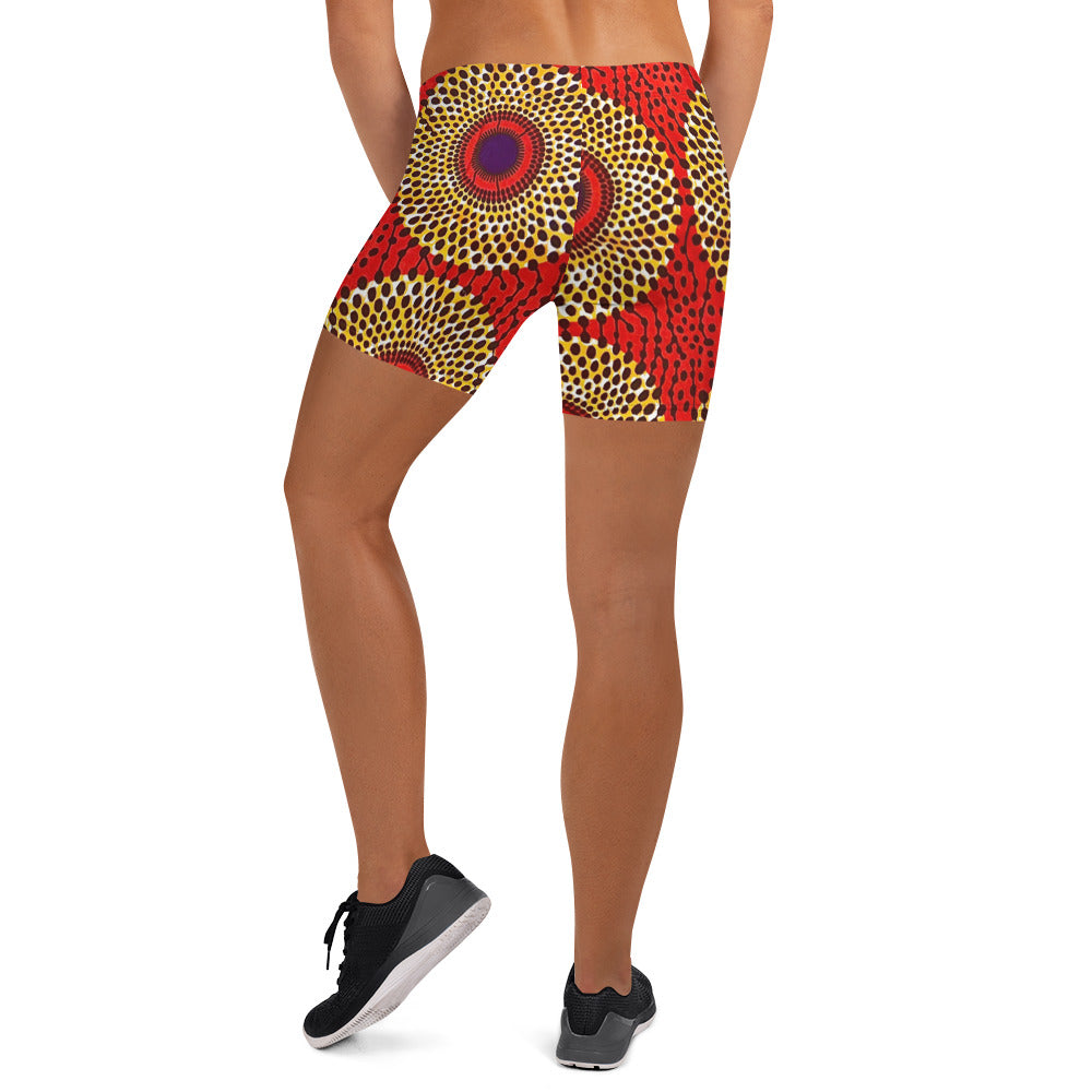 Back view of woman in sneakers wearing vibrant colored, geometric-pattern Rekiana African print athleisure sport shorts