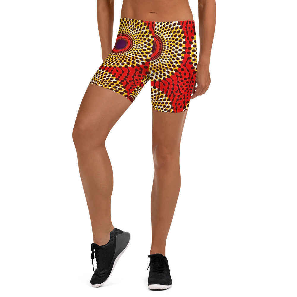 Front view of woman in sneakers wearing vibrant colored, geometric-pattern Rekiana African print athleisure sport shorts