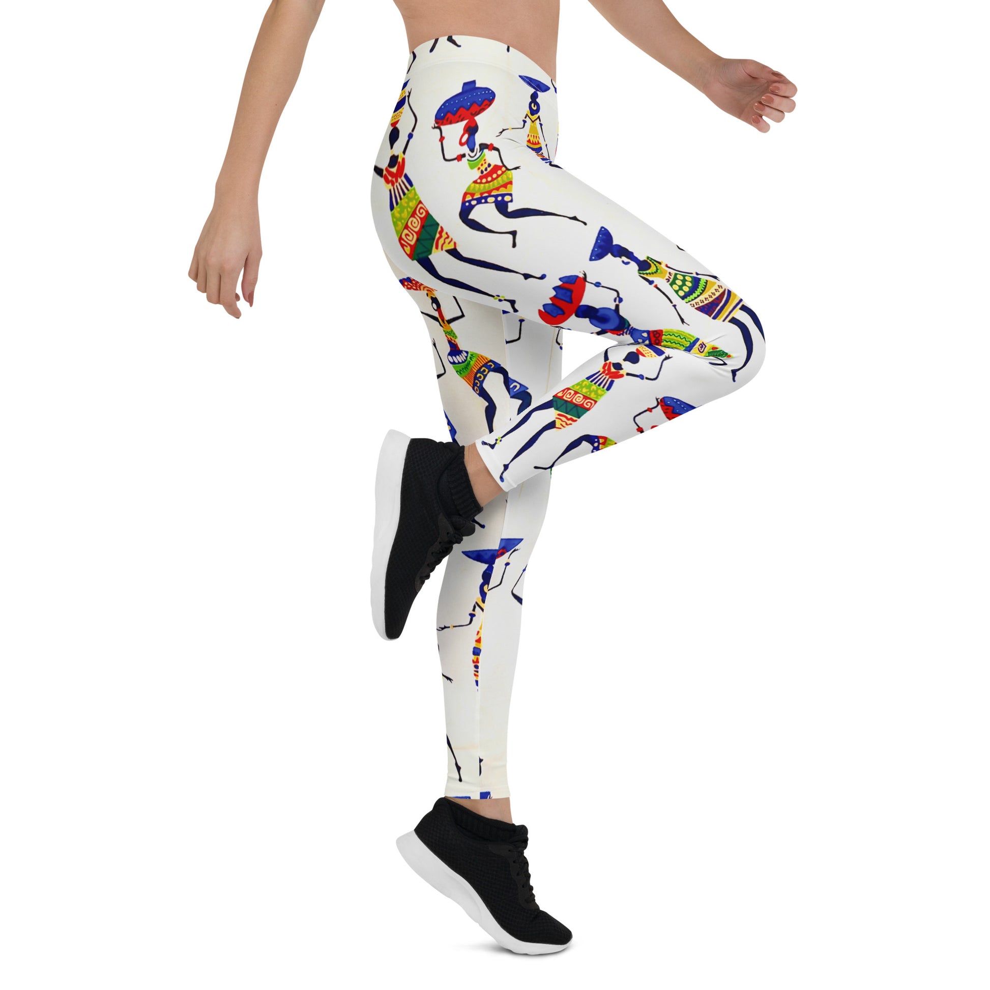 Side view of slim woman wearing sneakers and Yeye leggings; showcasing a close up view of the colorful depiction of African women dancing and carrying calabashes and jars