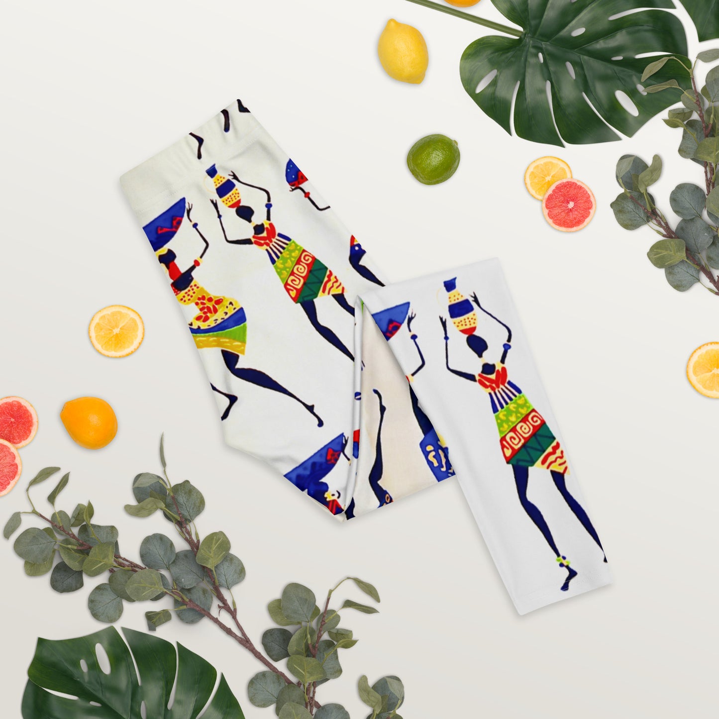 A summer vibe shoot of Yeye colorful leggings flanked by fruits and plants
