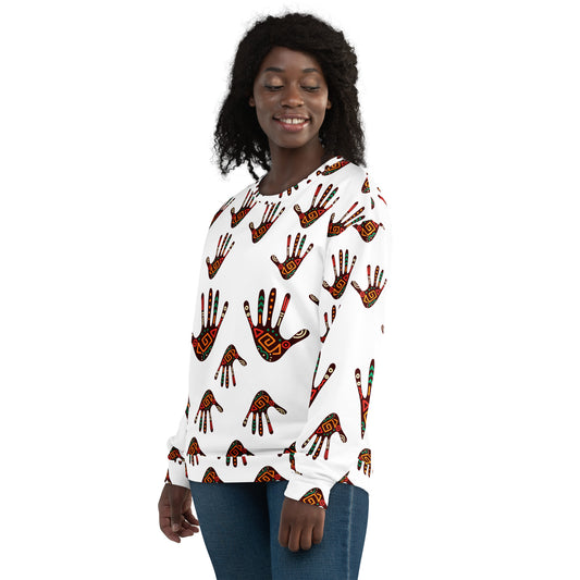 A person wearing a white unisex sweatshirt with a colorful tribal palm print design.