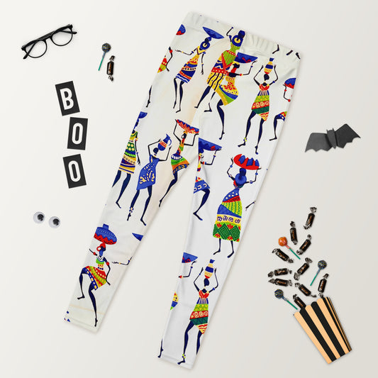 A pair of Yeye colorful leggings with an African print design of women bearing calabashes and jars; displayed alongside glasses, a mobile phone, and other accessories.