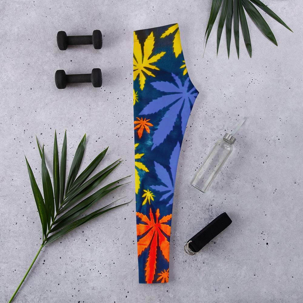 Side view of Mari Yoga Workout Athleisure Leggings; laid out with water bottle and dumb bells, and flanked by leaves