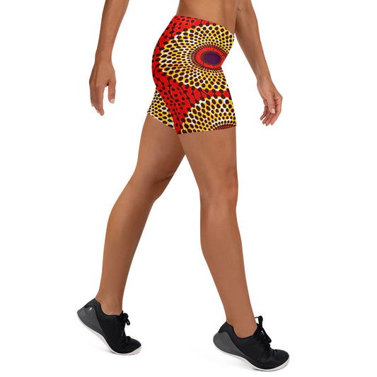 Side view of woman wearing vibrant colored, geometric-pattern Rekiana African print athleisure sport shorts