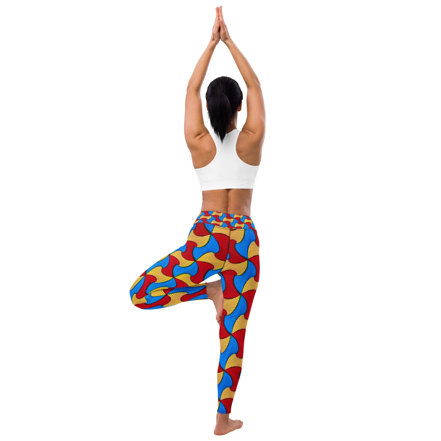 Back view of woman standing in a yoga pose; one foot braced on the inside of her knees, while wearing Santi Ankara Print Leggings