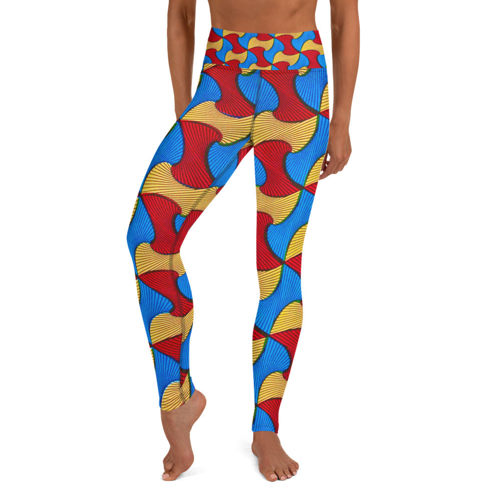 Front view of barefoot woman wearing Santi Athleisure leggings; close up view of vibrant blue, yellow and red colored geometric pattern.