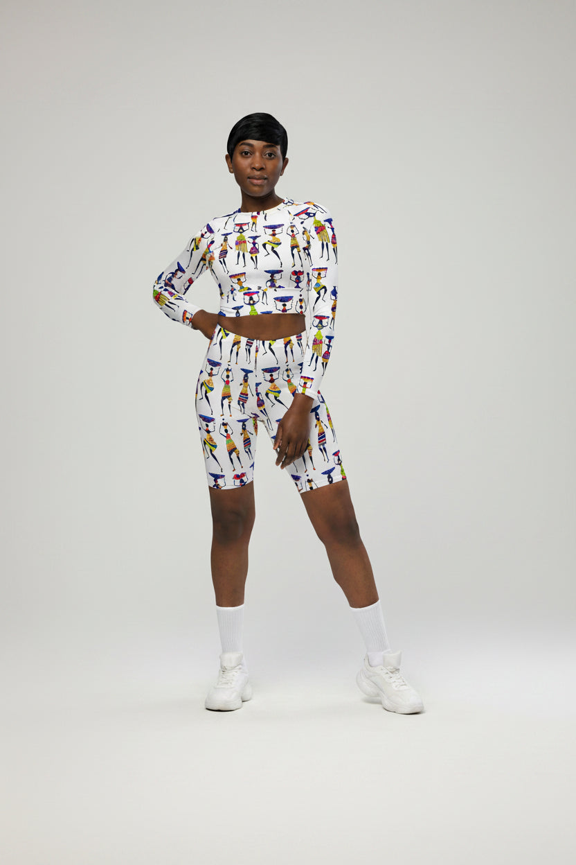 A woman wearing a long-sleeve crop top with a colorful geometric pattern.
