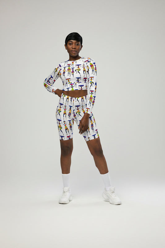 A woman wearing a long-sleeve crop top with a colorful geometric pattern.